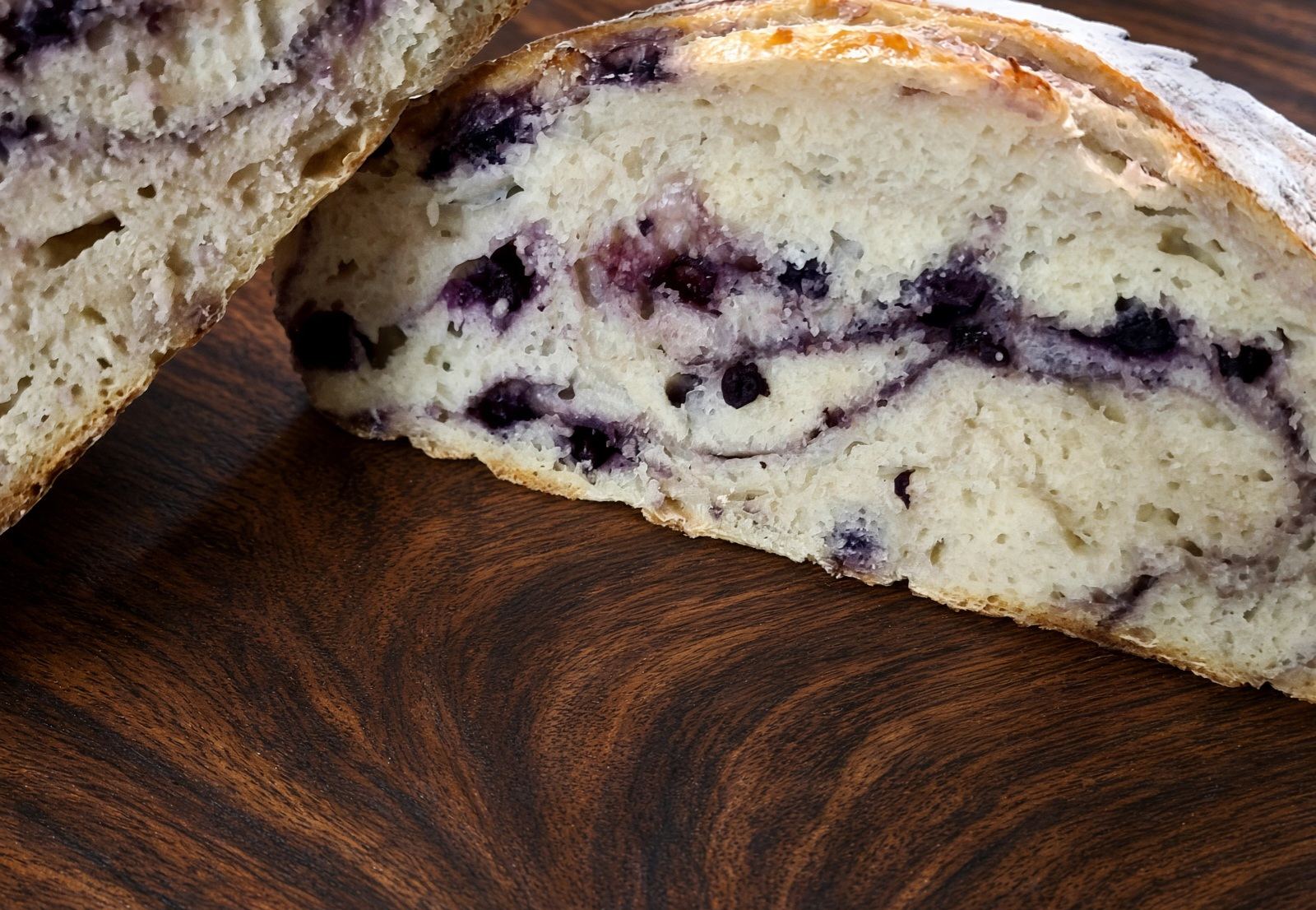 Slices of blueberry, honey and lemon sourdough showing purple swirls